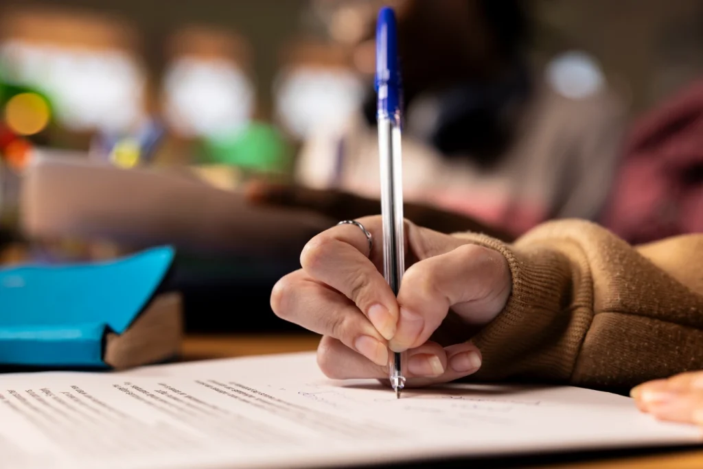 Hand writing on paper with a pen