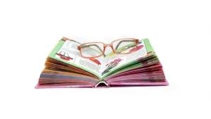 Open children's book with reading glasses