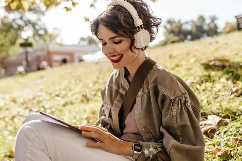 Woman listening to audio with headphones outside